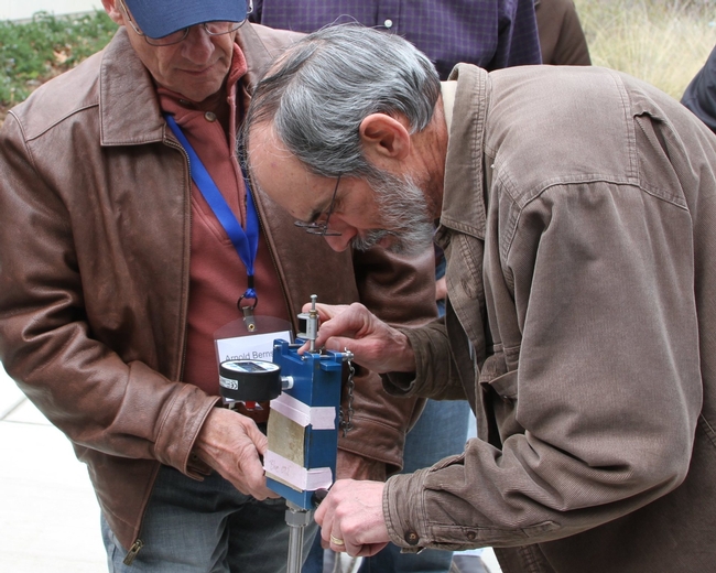 Ken Shackel (right) demonstrates a pressure chamber