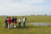 Students gather near a vernal pool on the nature preserve on the UC Merced campus.