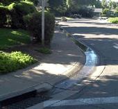 Urban water runs into storm drain.