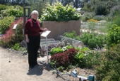 Rose Hayden-Smith in front of a demonstration Victory Garden.