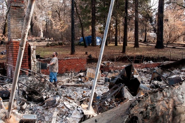 A Paradise resident survey's is home destroyed by the Camp Fire in Butte County. (Photo: 25th Air Force 25af.af.mil)