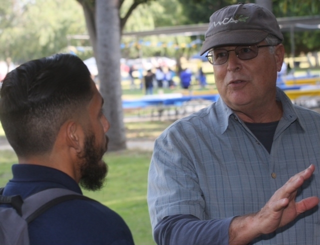 UCCE horticulture advisor Don Hodel, right, said fig trees at El Pueblo de Los Angeles Historical Monument become unhealthy when the ground beneath the canopy is covered with concrete, preventing fallen leaves from decomposing and enriching the soil.