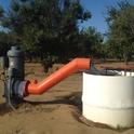 Groundwater is drawn by a pump to irrigate almonds in Fresno County.