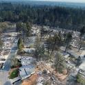 Drone footage of the Camp Fire aftermath shows homes destroyed while green trees are unscathed.