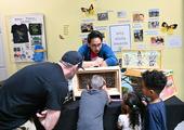 UC Davis entomology graduate student Richard Martinez encourages attendees to find the queen in the bee observation hive. (Photo by Kathy Keatley Garvey)