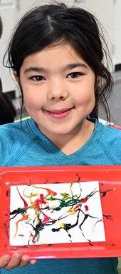 Phoenix Leeper, 6, of Davis shows her masterpiece: maggot art. (Photo by Kathy Keatley Garvey)