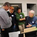 In this 2017 archived photo, Jerry Powell (seated at microscope) talks to colleagues at a Lepidopterist Society meeting at the Bohart Museum of Entomology. From left are entomologist Max Klepikov of Berkeley; UC Davis distinguished professor Don Strong of the  Department of Evolution and Ecology; and Eric Lopresti, then a UC Davis graduate student. (Photo by Kathy Keatley Garvey)
