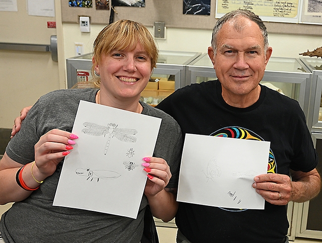 Rosser Garrison and his daughter, Anna Garrison, display their insect drawings. They participated in a class taught at a Bohart Museum of Entomology open house by  Professor Miguel Angel Miranda of the University of the Balearic Islands, Spain. (Photo by Kathy Keatley Garvey)