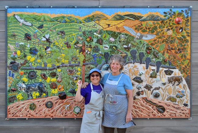 UC Davis distinguished professor Diane Ullman (right) with UC Davis  retired lecturer artist/retired lecturer in the Department of Design, an integral part of the mural project.