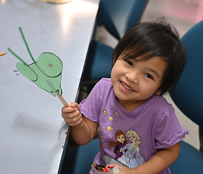 Julietta Millsop, 3, shows her Mantis on a Stick. (Photo by Kathy Keatley Garvey)