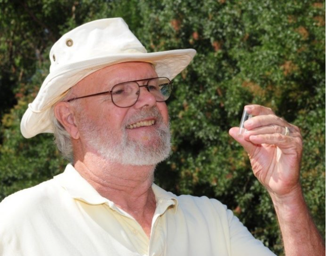 UC Davis distinguished emeritus professor Robbin Thorp (1933-2019) examines a vial containing a bumble bee. (Photo by Kathy Keatley Garvey)