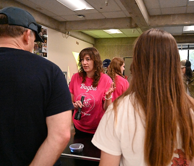 Marielle Hansel Friedman of the Emily Meineke lab talks about scorpions to visitors at Briggs Hall during the UC Davis Picnic Day. In back is Em Jochim of the Jason Bond lab. (Photo by Kathy Keatley Garvey)
