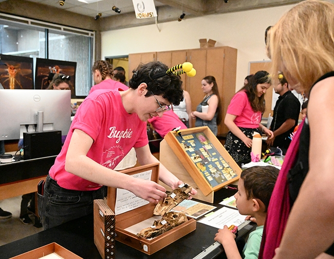UC Davis doctoral candidate Danielle Rutkowski talks to visitors at the Rachel Vannette lab display in Briggs Hall during the 2024 UC Davis Picnic Day. (Photo by Kathy Keatley Garvey)