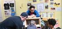 UC Davis entomology graduate student Richard Martinez encourages attendees to find the queen in the bee observation hive. (Photo by Kathy Keatley Garvey) for Bug Squad Blog