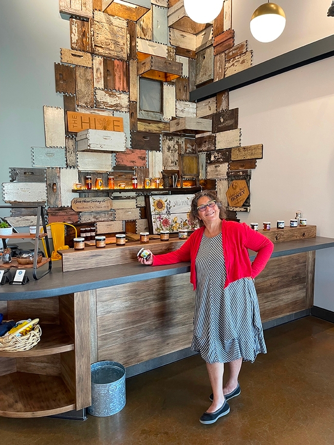 Amina Harris, founding director and emerita of the UC Davis Honey and Pollination Center, stands inside her family's business, The Hive, a community gathering place in Woodland that offers honey and mead tasting.