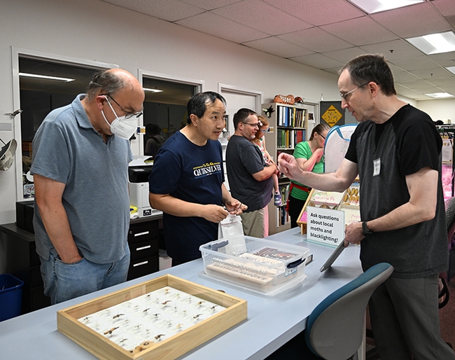 Moth-er Volkmar Heinrich, UC Davis associate professor of biomedical engineering, answers questions about moths at the Bohart Museum Moth Night. (Photo by Kathy Keatley Garvey)