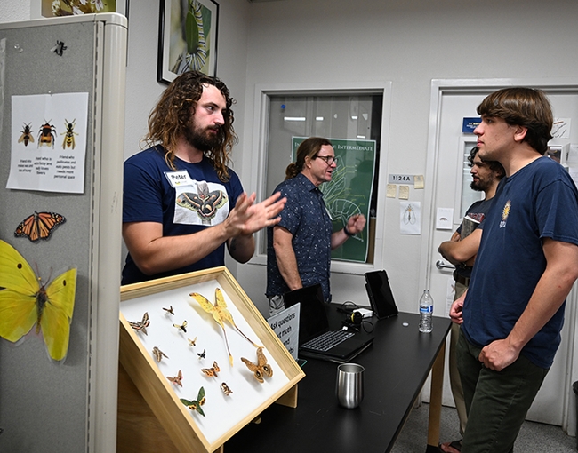 Father and son moth-ers, UC Davis doctoral candidate Peter Coggan (left) and Pete Coggan of Minnesota, answer questions about moths and light pollution. (Photo by Kathy Keatley Garvey)