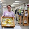 Tabatha Yang, education and outreach coordinator for the Bohart Museum of Entomology, holds a drawer of California dogface butterfly specimens. The butterfly is California's state insect. (Photo by Kathy Keatley Garvey)