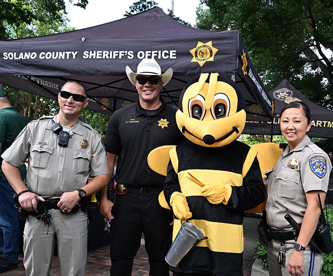 The Solano County Sheriff's Department, Vacaville Police Department and California Highway Patrol all participated in the Museum Guild's Children's Party. The Honey Bee took time out to pose with several of the officers. From left are CHP Officer Mike Barday, Sheriff Sgt. Rex Hawkins, and CHP Officer Erica Tatum. (Photo by Kathy Keatley Garvey)