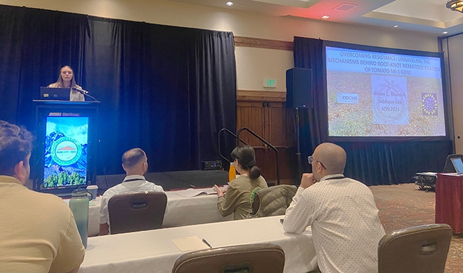 Doctoral candidate Alison Blundell delivering her award-winning presentation in the 12-minute student competition at the international Society of Nematologists. She won second place. (Photo by Veronica Casey)