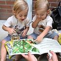 A children's book on the California state insect, the dogface butterfly, draws the interest of twins Ford and Wyatt Devine, 2, of Vacaville.The book was displayed at the Vacaville Museum Guild's Children's Party. (Photo by Kathy Keatley Garvey)