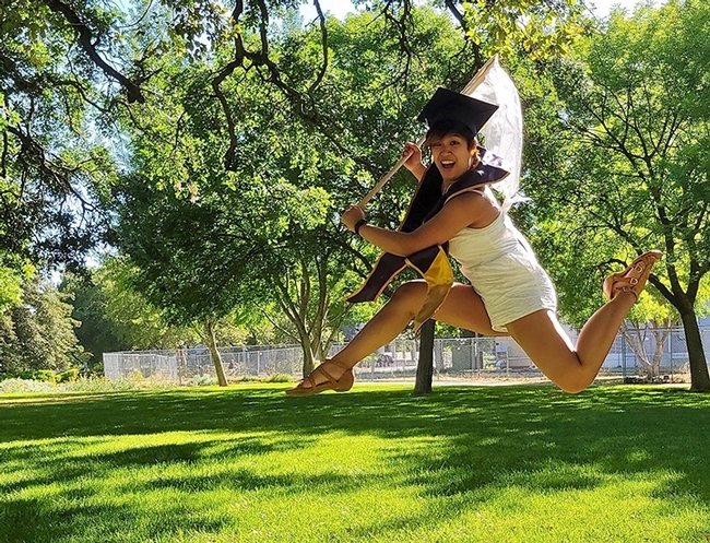 This image of UC Davis entomology graduate RJ Millena shows her jumping for joy while wielding an insect net. (Photo taken in 2021 by Kaylee Fagan)