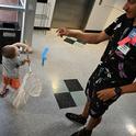 Braden Nguyen, 3, of Davis, stretches to net a paper butterfly tossed by UC Davis doctoral student Christofer Brothers at the Bohart Museum of Entomology open house. (Photo by Kathy Keatley Garvey)