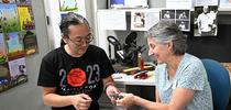 UC Davis alumnus Kevin Murakoshi gifts a leaf insect origami that he crafted to the Bohart Museum of Entomology. Accepting it is UC Davis distinguished professor emerita Lynn Kimsey, former Bohart Museum director and now executive director of the Bohart Museum Society. (Photo by Kathy Keatley Garvey) for Bug Squad Blog