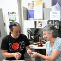 UC Davis alumnus Kevin Murakoshi gifts a leaf insect origami that he crafted to the Bohart Museum of Entomology. Accepting it is UC Davis distinguished professor emerita Lynn Kimsey, former Bohart Museum director and now executive director of the Bohart Museum Society. (Photo by Kathy Keatley Garvey)