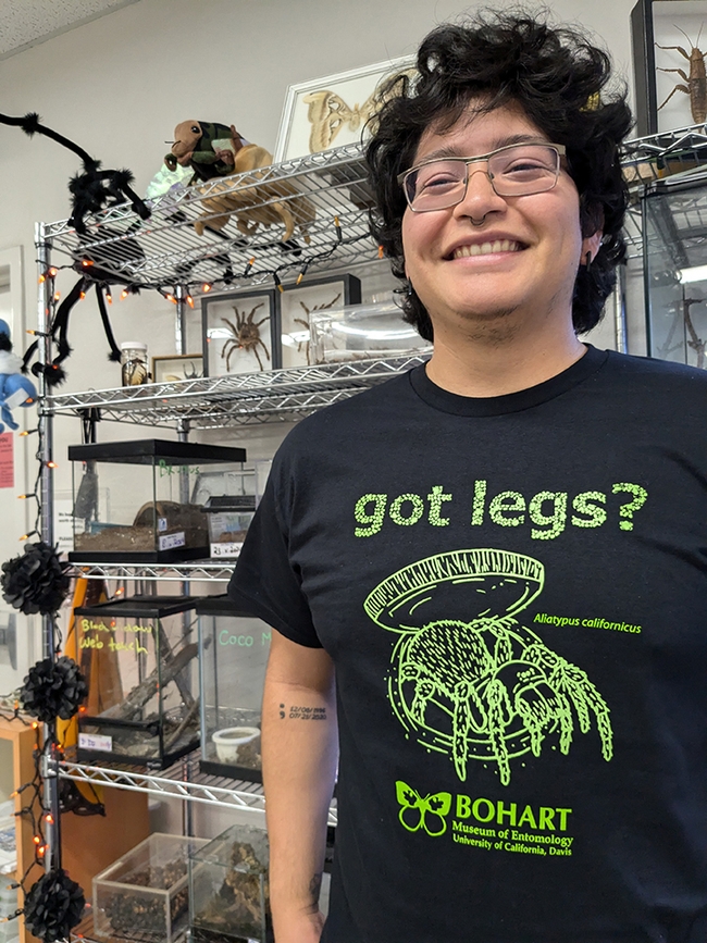 UC Davis student Jakob Lopez, a Bohart Museum employee, wearing the glow-in-the-dark trapdoor spider T-shirt. The cost is $22 plus tax for adult sizes and $18 plus tax for youth. Proceeds support the museum.