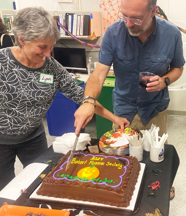 UC Davis distinguished professor emerita Lynn Kimsey, former Bohart Museum director, and Professor Jason Bond, who suceeded her, cut the Bohart Museum Society cake. (Photo by Greg Kareofelas)