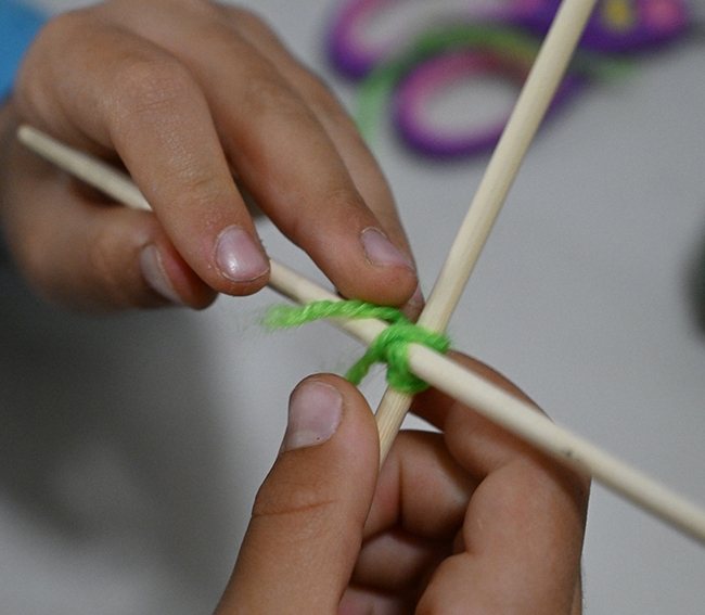 Close-up of the hands of Levon Sahakian Frenz working the yarn. (Photo by Kathy Keatley Garvey)