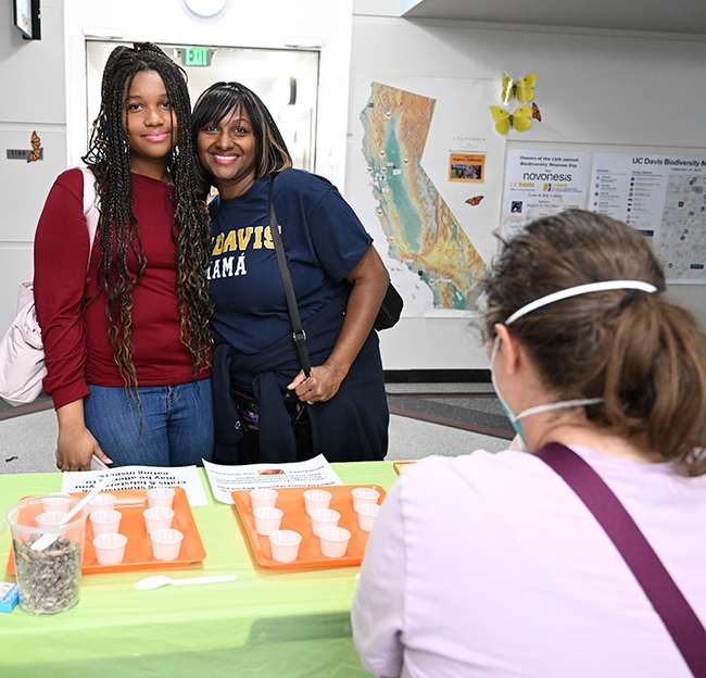 UC Davis student Nia Rhodes, an atmospheric science major, stopped by the cricket booth with her mother, Elizabeth Rhodes of Los Angeles, who is wearing a 