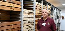 Jeff Smith, curator of the Lepidoptera collection at the Bohart Museum, stands by the drawers he crafted. (Photo by Kathy Keatley Garvey) for Bug Squad Blog