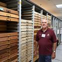 Jeff Smith, curator of the Lepidoptera collection at the Bohart Museum, stands by the drawers he crafted. (Photo by Kathy Keatley Garvey)