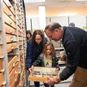 UC Davis professor Jason Bond, director of the Bohart Museum, shows butterfly specimens to Woodland residents Olive Smith, 8, and her mother Sarah Smith. Bond is the Evert and Marion Schlinger Endowed Chair, UC Davis Department of Entomology and Nematology, and associate dean, UC Davis College of Agricultural and Environmental Sciences. (Photo by Kathy Keatley Garvey)