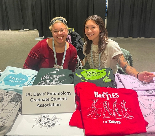 One of the UC Davis Entomology Graduate Student Association's most popular T-shirt is The Beetles T-shirt. Pictured are Iris Quayle (left), treasurer, and past president Mia Lippey. Graduate students design and sell T-shirts.