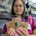 Bohart Museum of Entomology student intern Jasmine Chow holds a selection of bug pins available in the museum's gift shop.