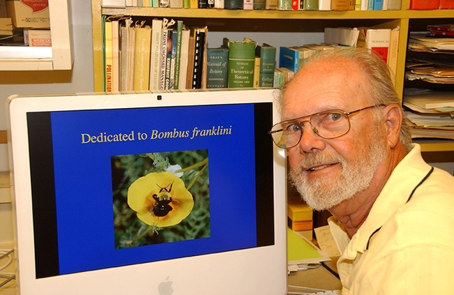 UC Davis distinguished emeritus professor Robbin Thorp (1933-2019) with his screen saver image of Franklin's bumble bee. (Photo by Kathy Keatley Garvey)