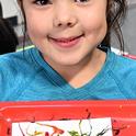 Phoenix Leeper, 6, of Davis shows her masterpiece: maggot art. (Photo by Kathy Keatley Garvey)