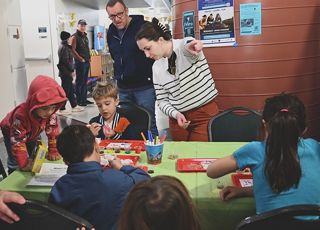 Entomologist Riley Hoffman  at the maggot art table at the Bohart Museum of Entomology open house. (Photo by Kathy Keatley Garvey)