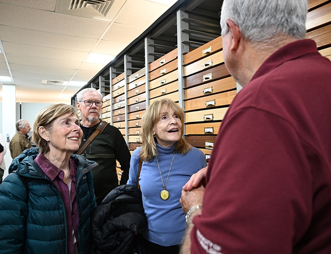 Jeff Smith (foreground), curator of the Lepidoptera collection, holds the rapt attention of three retirees: Susan Knadle (left) and her husband Chuck Salocks of Davis and Carrye Cooper of Redondo Beach. (Photo by Kathy Keatley Garvey)