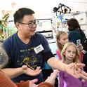 Bohart Museum associate and UC Davis entomology major Kaitai Liu delights in showing insects from the petting zoo to the crowd. (Photo by Kathy Keatley Garvey)