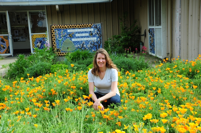 Beekeeper Elizabeth Frost in front of the pollinator patch she planted. (Photo by Kathy Keatley Garvey)