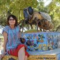 Donna Billick with her ceramic mosaic sculpture of a honey bee in the Haagen-Dazs Honey Bee Haven. (Photo by Kathy Keatley Garvey)