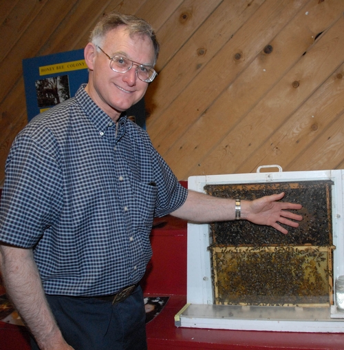 UC EXTENSION APICULTURIST Eric Mussen with a bee observation hive at the 2008 Dixon May Fair. The exhibit, featuring question-and-answer-sessions with Mussen, just won second place in a Western Fairs Association competition. (Photo by Kathy Keatley Garvey)