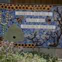 The sign in front of the Laidlaw facility includes bees, a skep, almond blossoms and DNA. It is the work of artist Donna Billick of Davis, a co-founder and co-director of the UC Davis Art/Science Fusion Program. (Photo by Kathy Keatley Garvey)