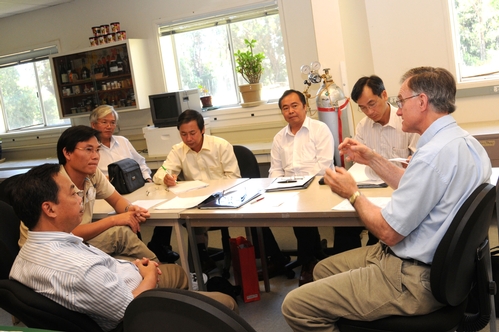 ALL ABOUT THE BEES--Discussing honey bees are (clockwise, from far left) Vietnamese scientists Nguyen Tai, Luong Hong Quang, Bui Van Mien, Le Minh Hoang, Nguyen Hay, Hoang Nhu Tung and UC Cooperative Extension Apiculturist Eric Mussen. (Photo by Kathy Keatley Garvey)