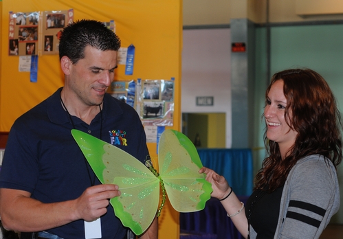 BUTTERFLIES abound at the Solano County Fair. Here assistant fair manager Chad Cabral (left) and Elisa Seppa, superintendent of McCormack Hall, look over a butterfly decoration. (Photo by Kathy Keatley Garvey)