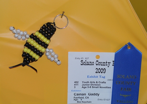 A HONEY BEE is transformed into a key chain at McCormack Hall, Solano County Fair. This is the work of Cainan Gaddy, 6, of Fairfield. (Photo by Kathy Keatley Gavey)